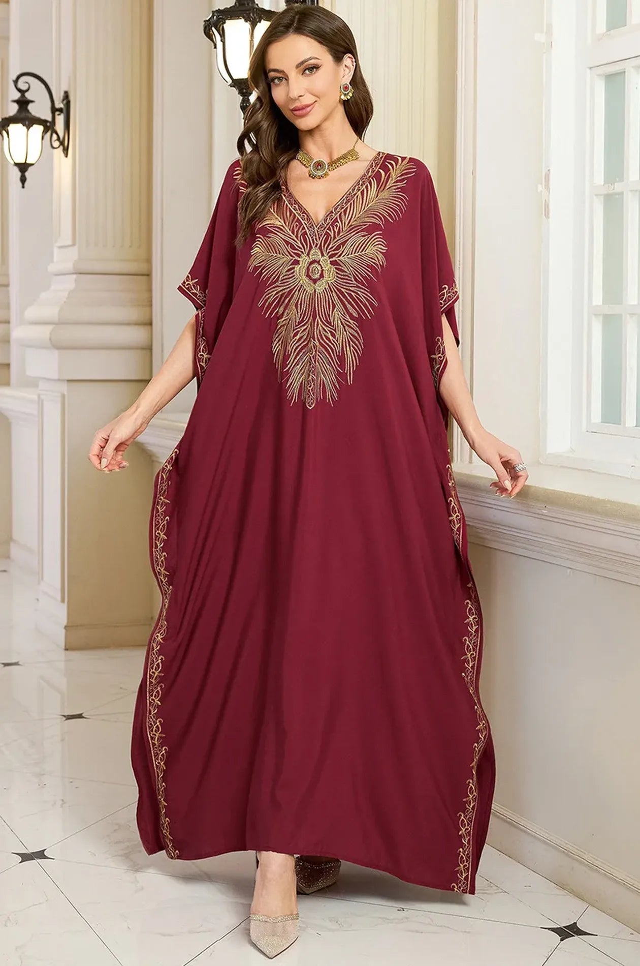 Naylara Laurel red embroidered kaftan butterfly sleeves — front view palace interior setting