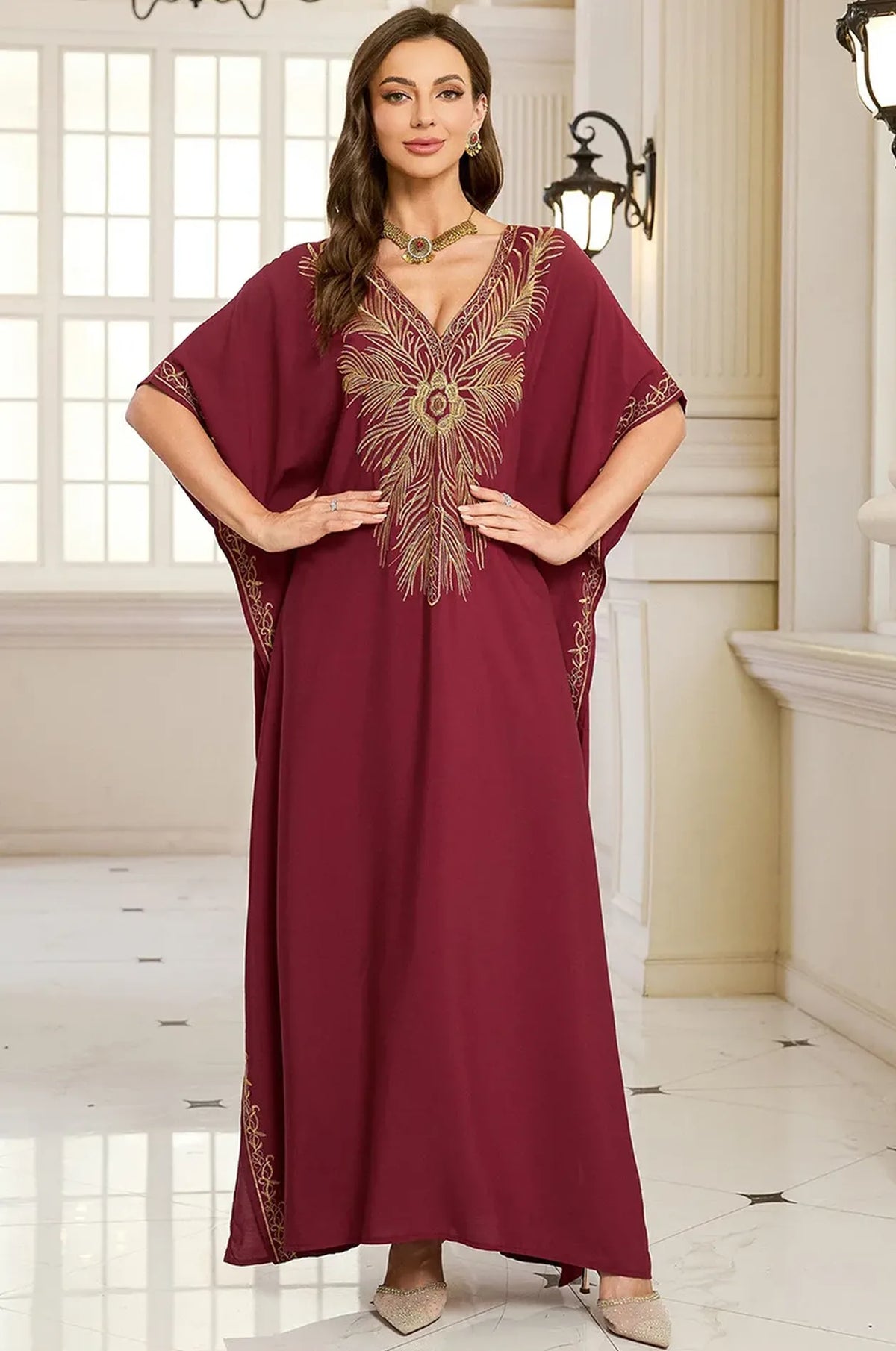 Naylara Laurel red embroidered kaftan — front view with side slit detail palace interior