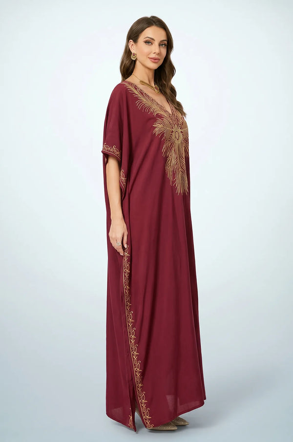 Side profile of Naylara Laurel red Moroccan kaftan with gold feather embroidery and side slit