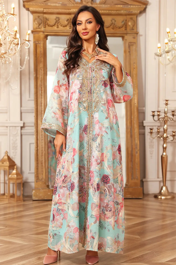 Frontal view of the Naylara Lyrae blue floral kaftan standing in a palatial room, showcasing the flowing sheer fabric.