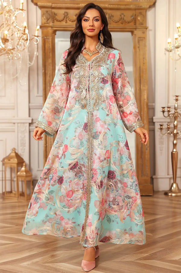 A full-length dynamic view of the blue Lyrae kaftan emphasizing the vibrant rose print and lightweight silhouette.