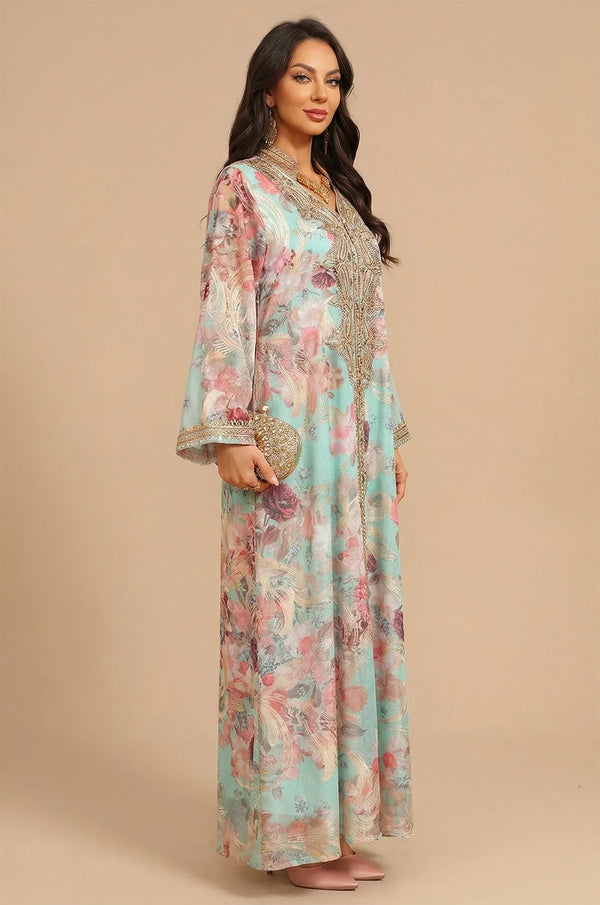 Three-quarter view of the blue Lyrae kaftan styled with a gold clutch bag and traditional gold jewelry.