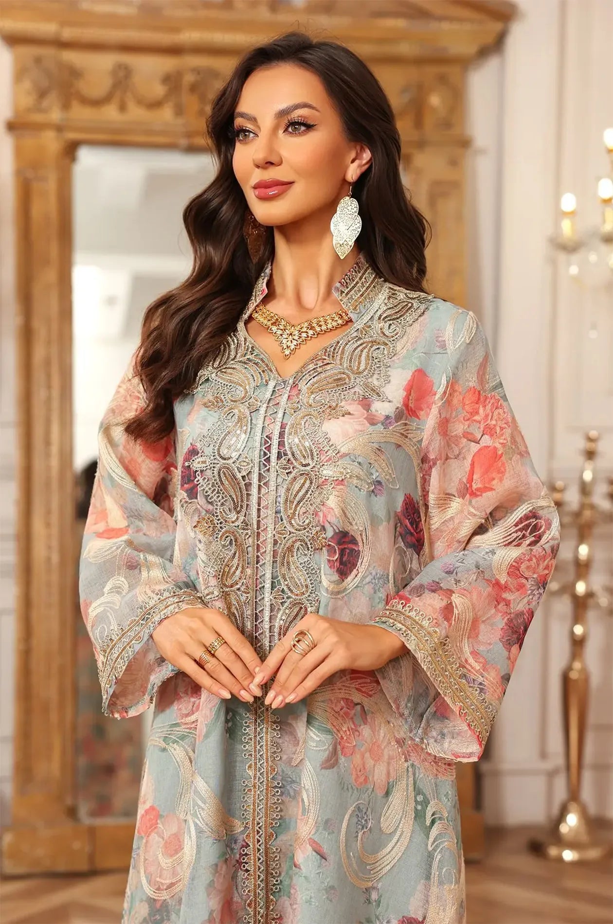 Detailed medium shot of the green Lyrae floral kaftan showcasing the ornate gold paisley embroidery.