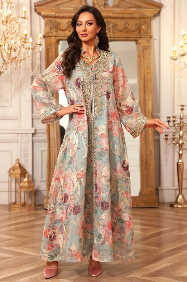 Model posing in the green Lyrae vintage embroidered kaftan, emphasizing the lightweight sheer fabric and floral design.