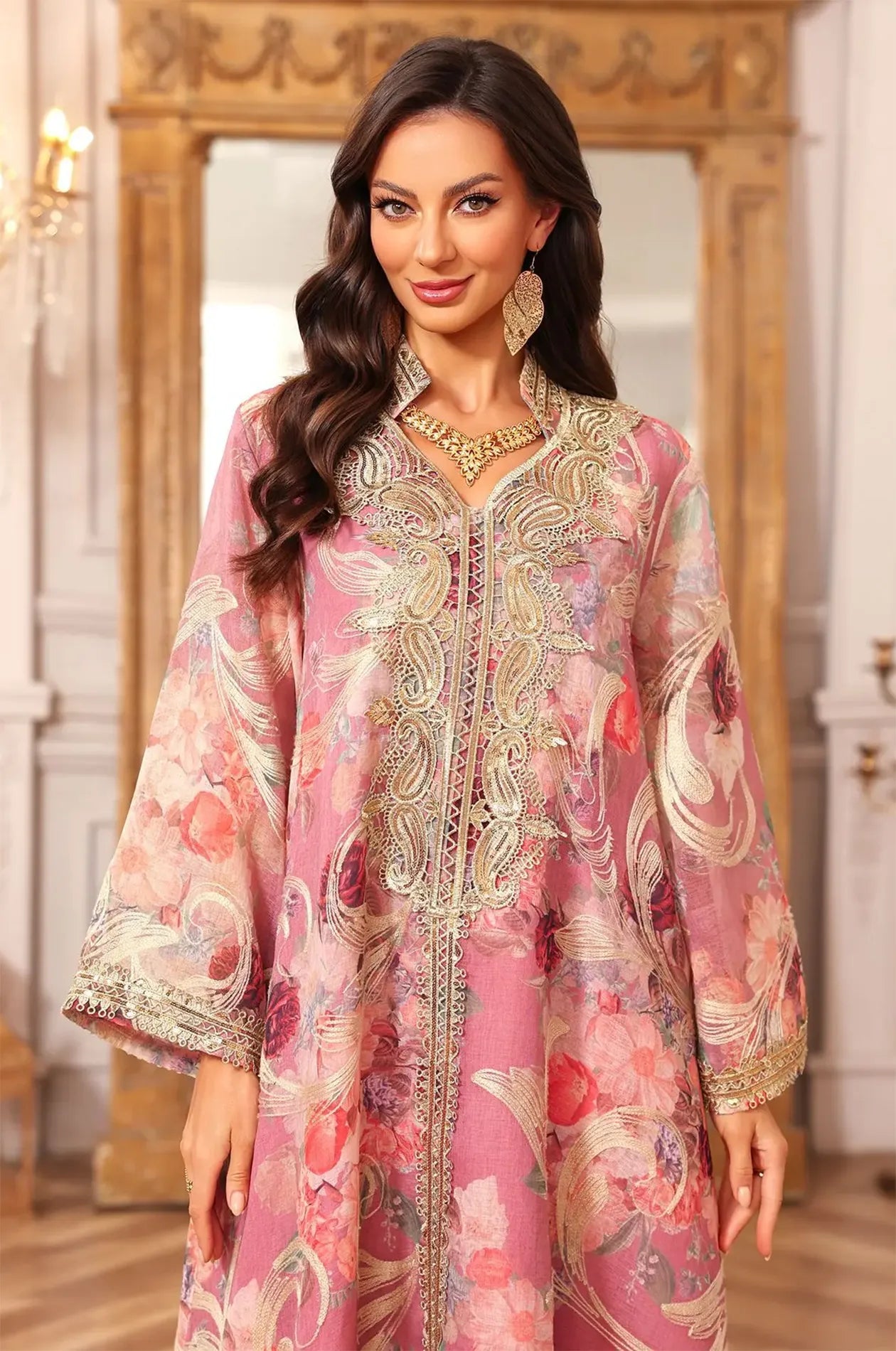 Close-up shot of the intricate gold embroidery and traditional button detailing on the bodice of the pink Lyrae kaftan.