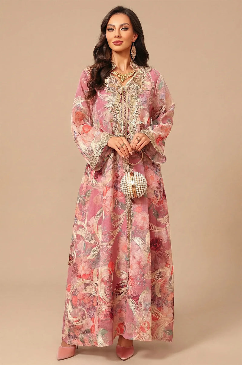 Full-length front view of the Naylara Lyrae pink vintage embroidered kaftan with rose floral print and a pearl-beaded circular handbag.