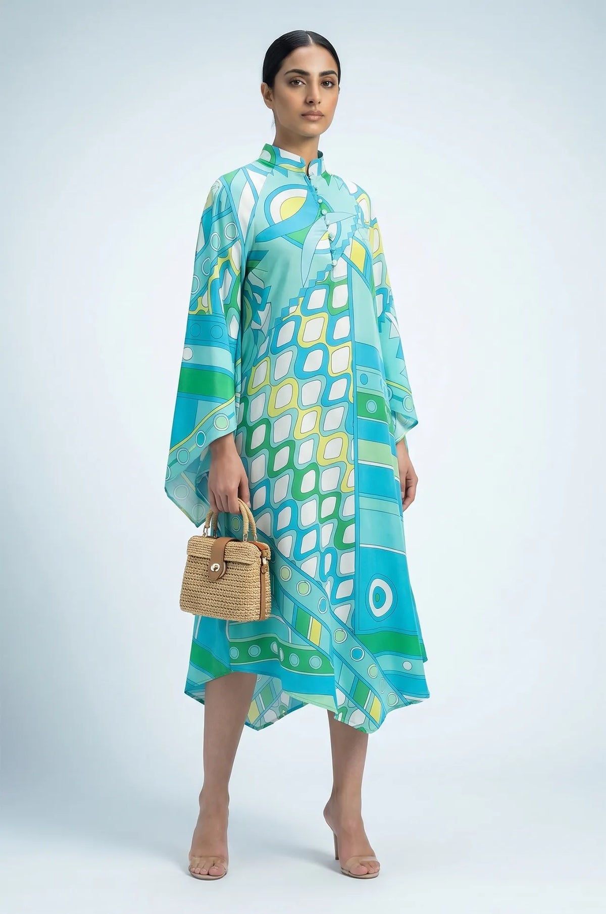 Naylara Myrtle teal print summer kaftan styled with raffia tote bag — three-quarter view