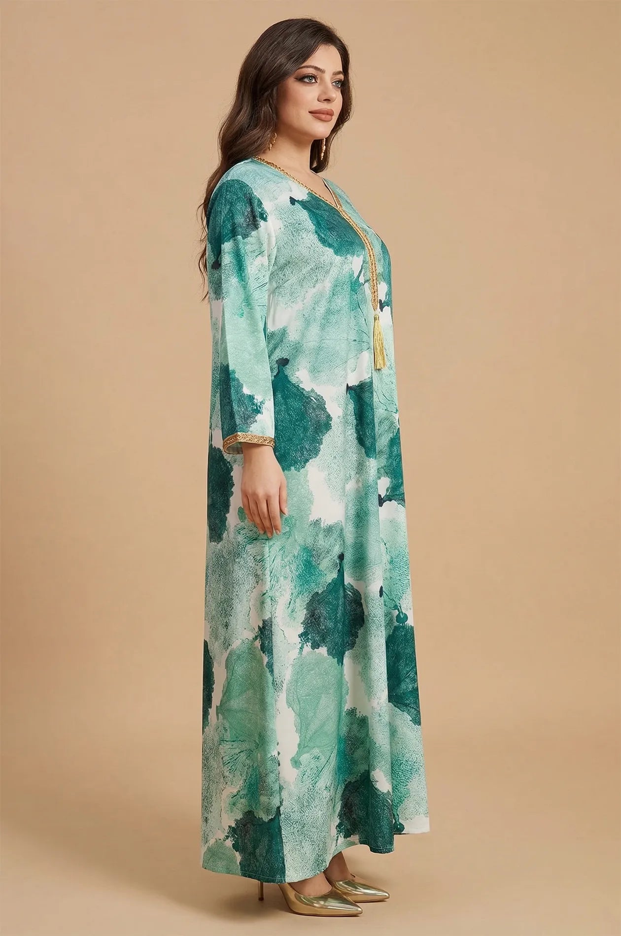 Side profile of the green Navae tropical print kaftan by Naylara, highlighting the flowing flared sleeves.