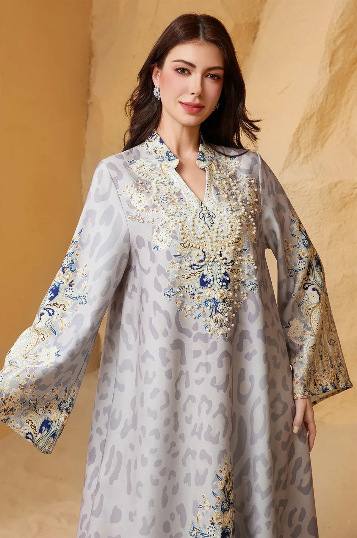 Close-up of the Nyx Gray Animal Print Kaftan by Naylara, showcasing the intricate hand-applied pearl beading and rhinestone embellishments on the V-neckline.