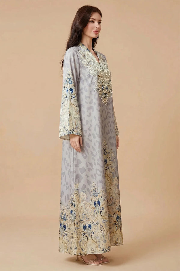 Side profile of a model wearing the Nyx Gray Kaftan, displaying the elegant drape of the lightweight fabric and the detailed print on the long bell sleeves.