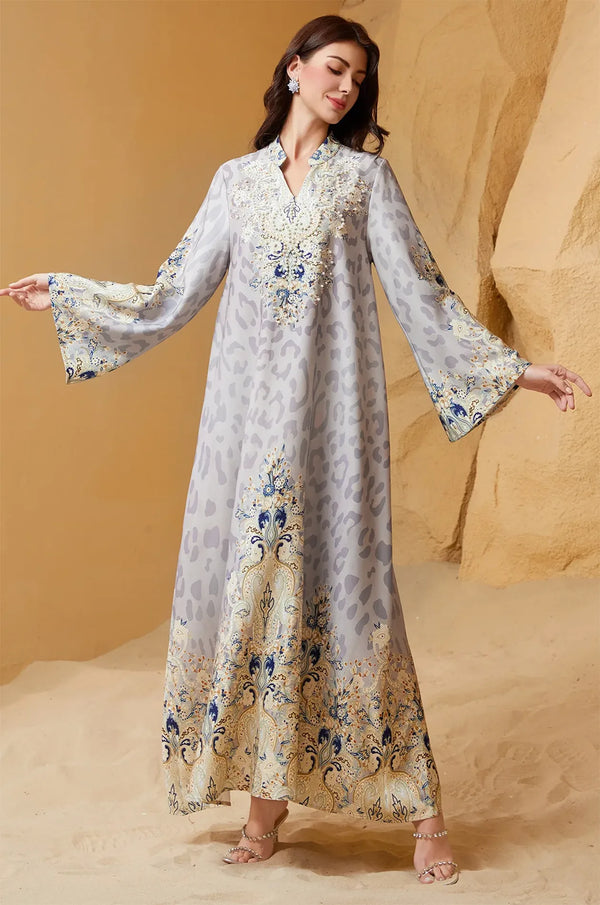Model posing with arms wide to show the butterfly-style bell sleeves and the expansive flowy fit of the Nyx Gray Animal Print Kaftan.