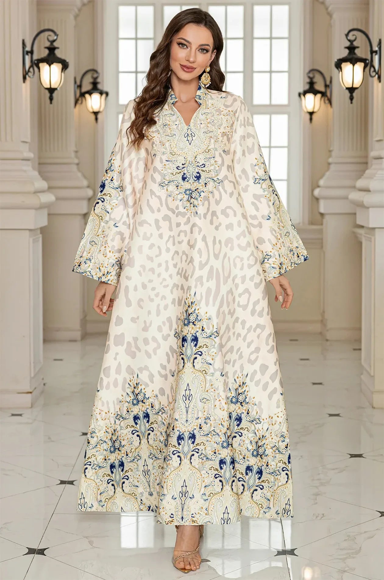 Full-length front view of the Nyx White Formal Kaftan Maxi Dress with long bell sleeves and a striking blue and gold ornamental border.