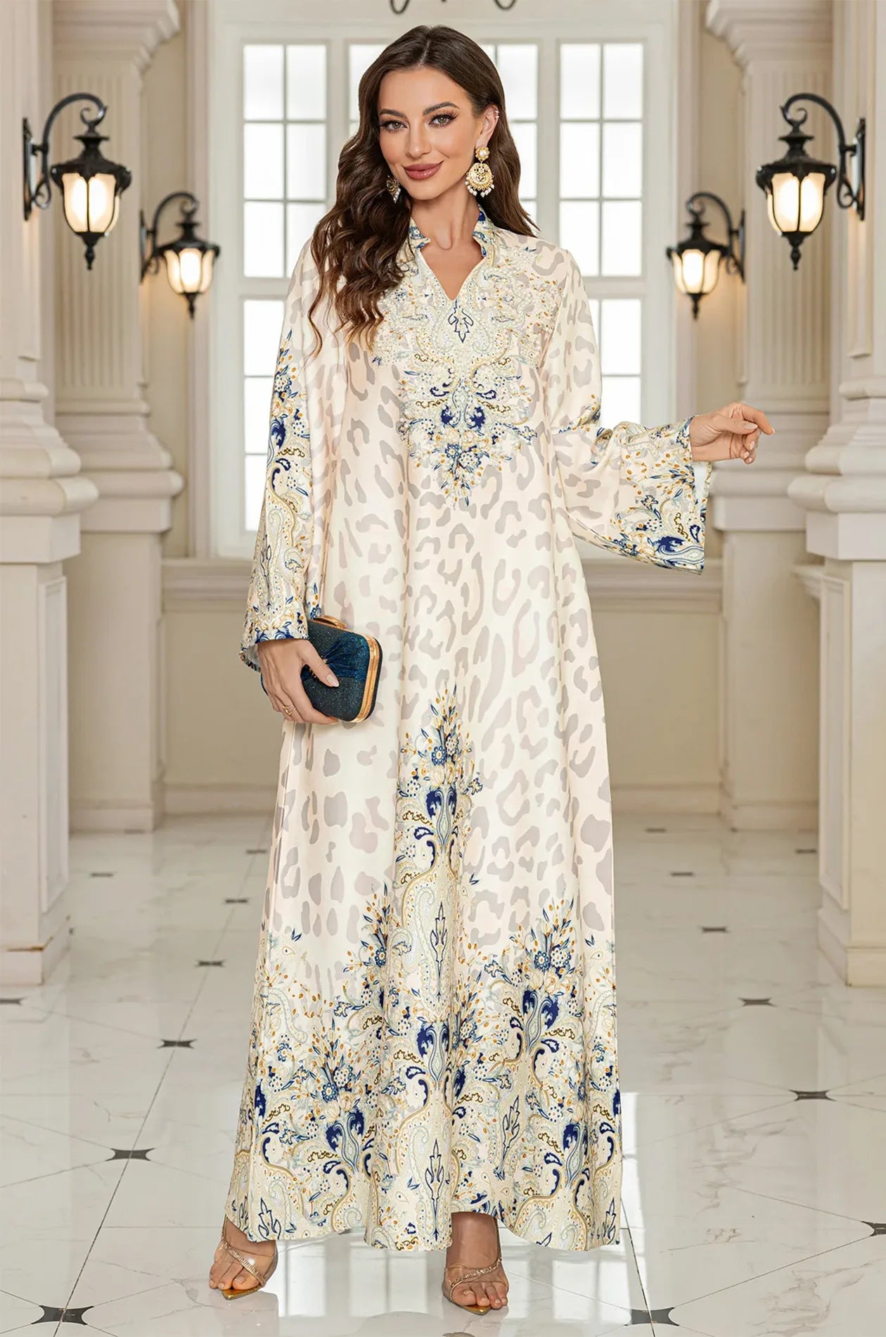 The Nyx White Kaftan accessorized with a luxury clutch, demonstrating a perfect outfit choice for weddings, parties, or formal occasions.