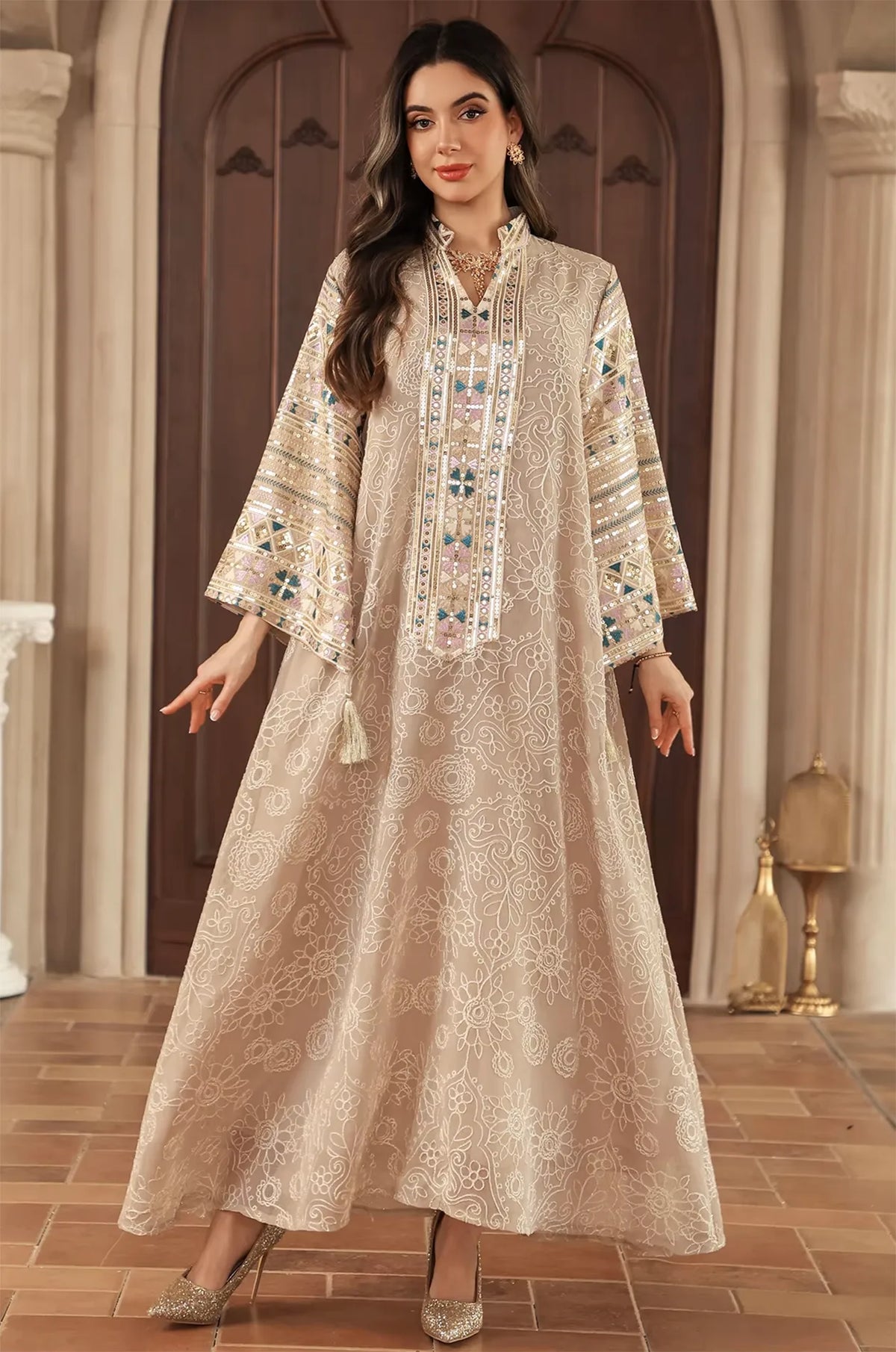 Full-length fashion pose of the Naylara Orla bell sleeve kaftan in apricot beige for wedding guest attire.