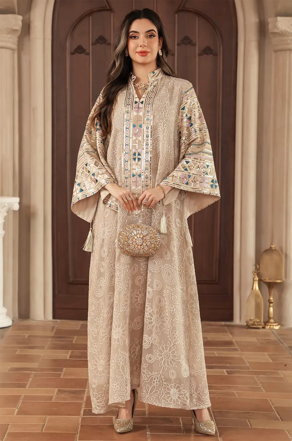 Formal evening styling of the Orla apricot beige bell sleeve kaftan featuring a luxury gold embellished bag.