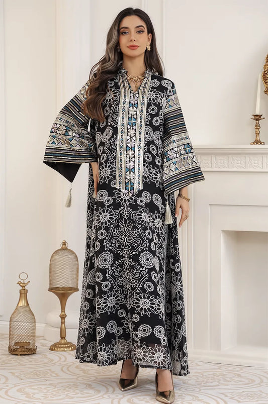 Fashion pose of the Naylara Orla black bell sleeve kaftan highlighting the fluid drape of the fabric and the wide, decorated sleeves.
