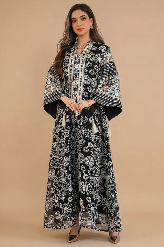 Full-length front view of the Orla black bell sleeve kaftan by Naylara showing the floor-length silhouette and hanging tassels.