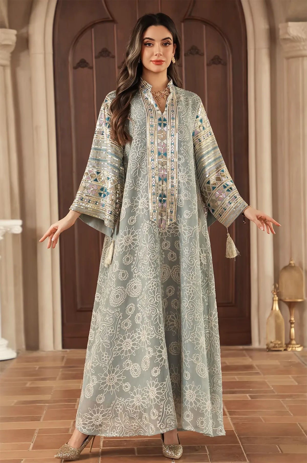Full-length lifestyle shot of the Orla light green bell sleeve kaftan in an elegant indoor setting.