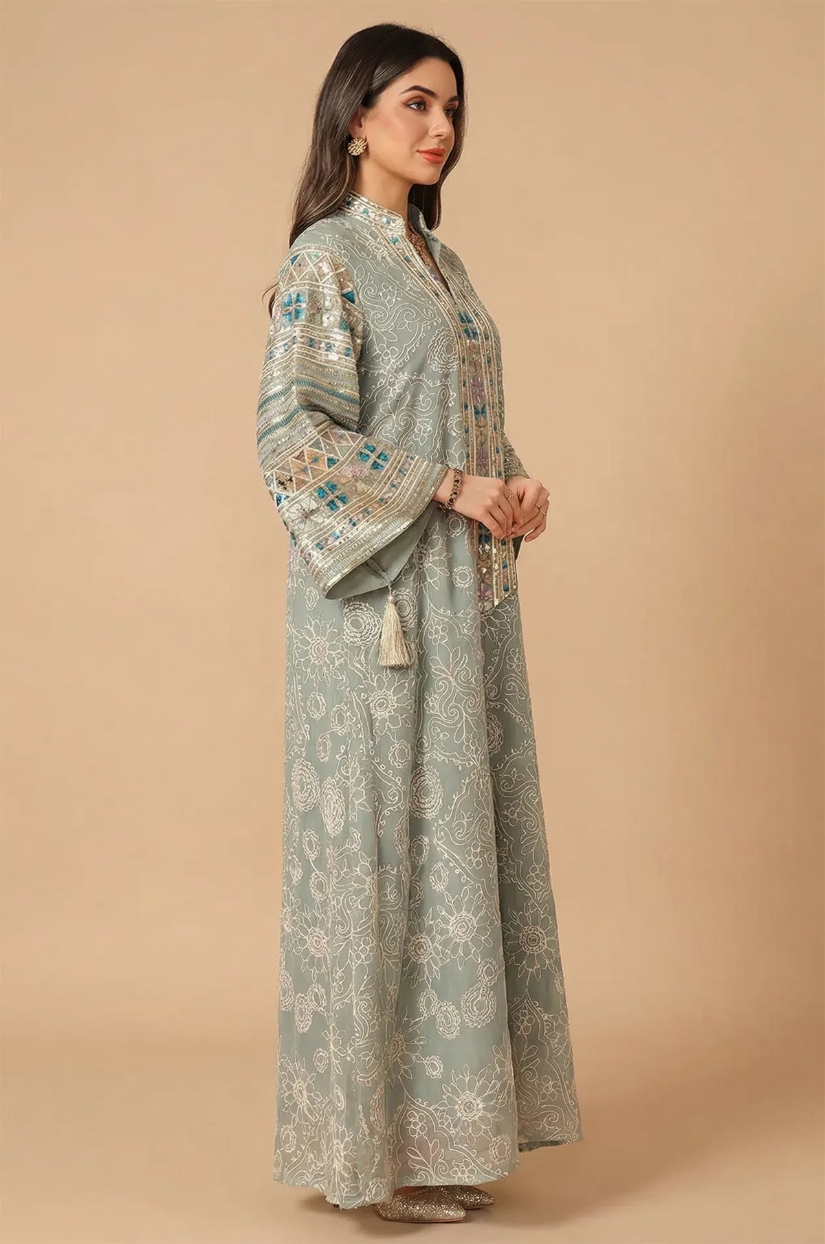 Side profile of the Orla light green kaftan highlighting the voluminous bell sleeves and geometric sequined trim.