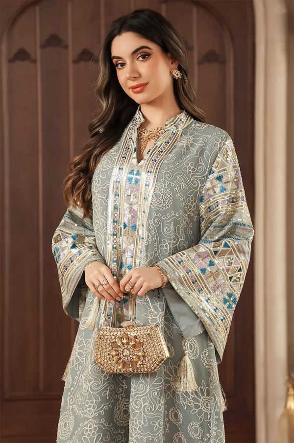 Elegant styling of the Orla light green bell sleeve kaftan with a gold beaded clutch and V-neck sequin detail.