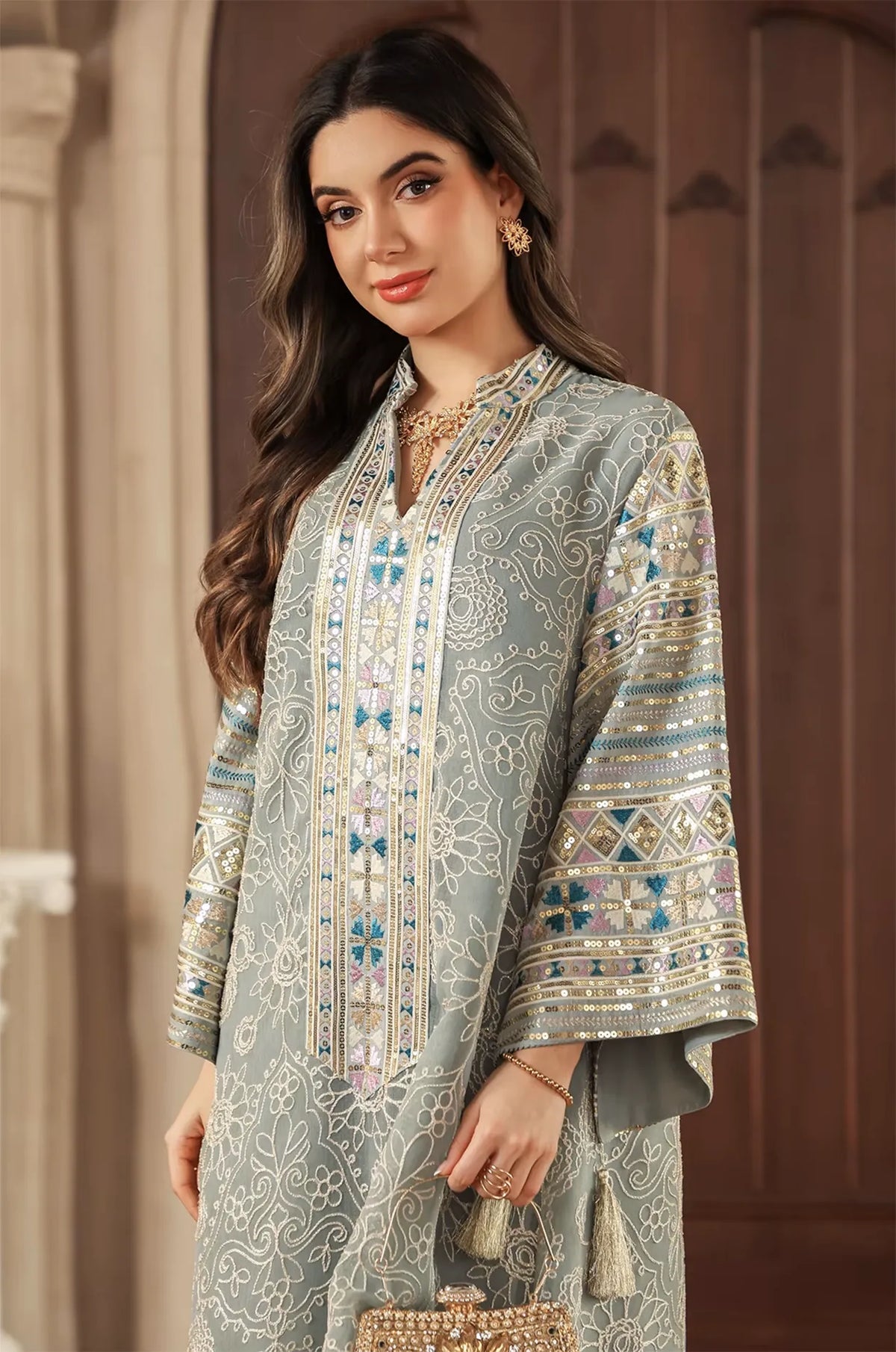 Close-up of the Orla light green kaftan’s upper body showing the embellished Mandarin collar and sleeve patterns.