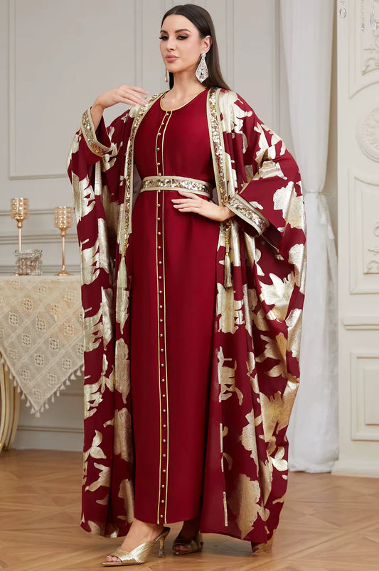 Full-length fashion shot of the red Puppis kaftan luxe by Naylara featuring hand-placed sequins and metallic gold floral brocade.