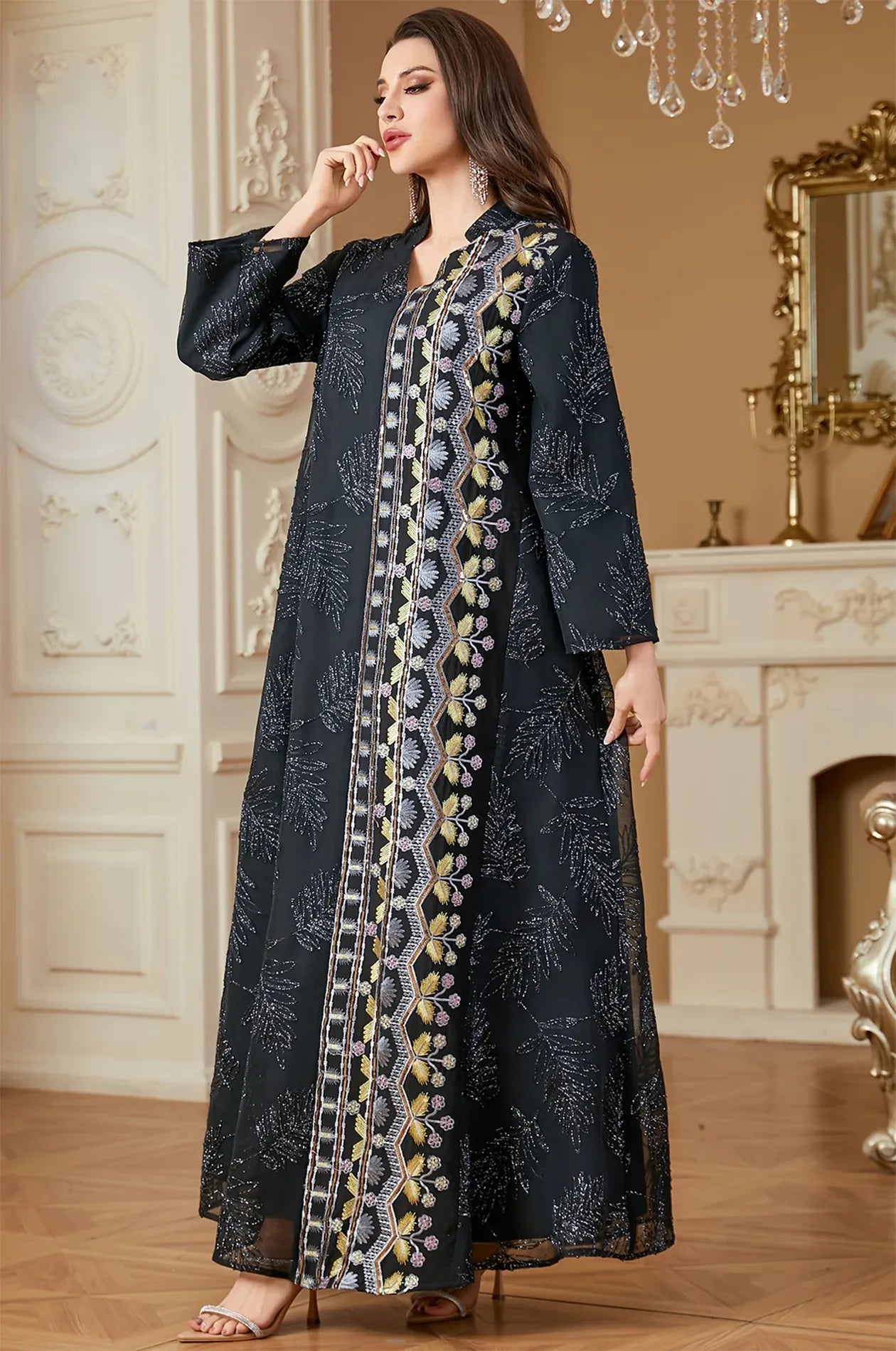 Model posing in the Saria black plus size sheer kaftan within a luxury interior, perfect for formal evening events.