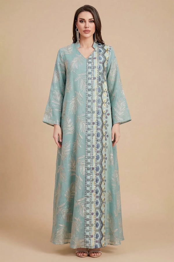 A full-length studio shot of the Saria gray sheer kaftan, an ideal evening gown for plus size silhouettes.