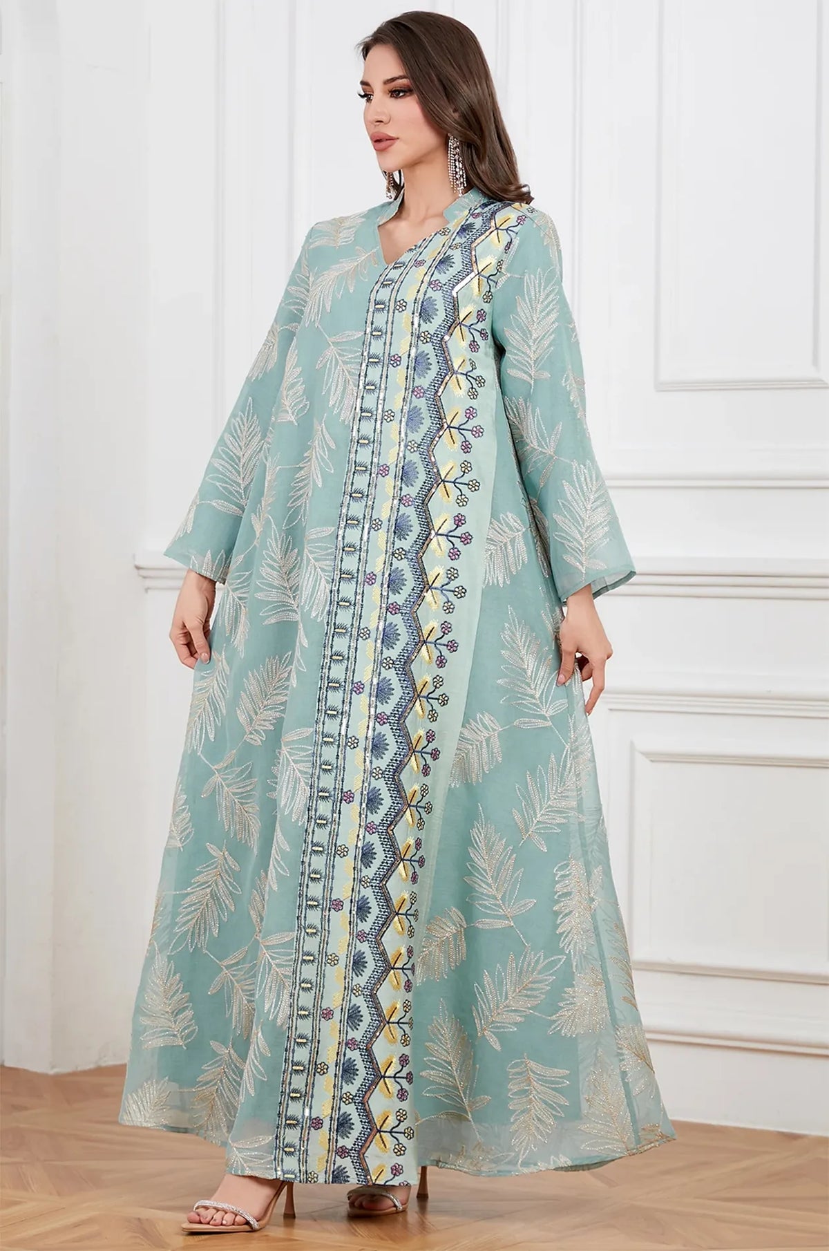 Movement shot of the lightweight gray sheer kaftan showcasing the fluid drape and delicate silver threading.