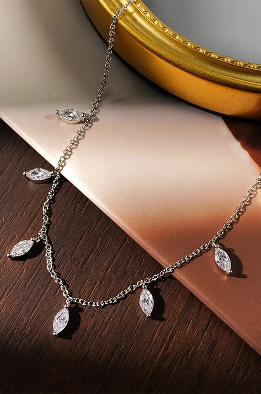 Sterling silver station necklace with leaf shaped stones on display