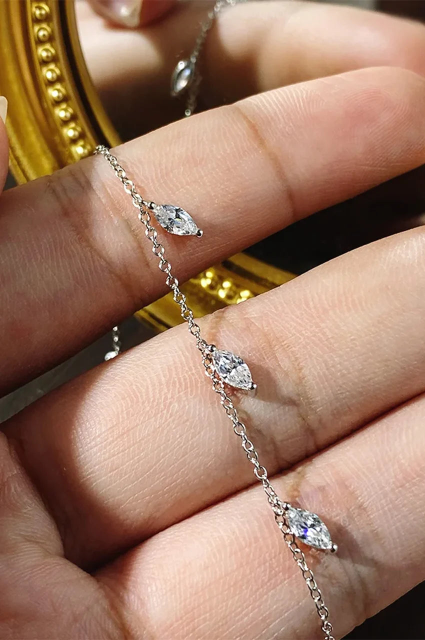 Macro shot showing the detail and sparkle of the marquise-cut cubic zirconia stones on the silver chain.