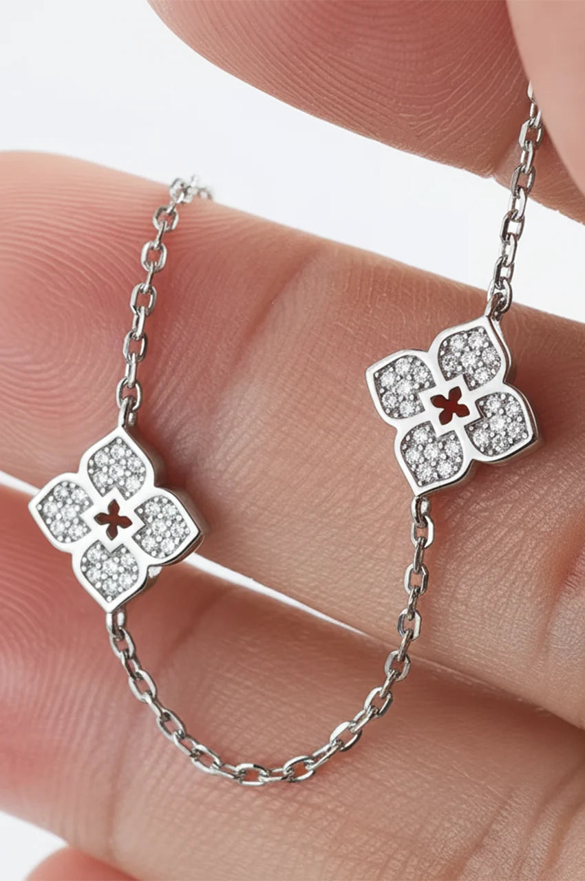 Hand holding silver chain necklace showing sparkle of moissanite stones