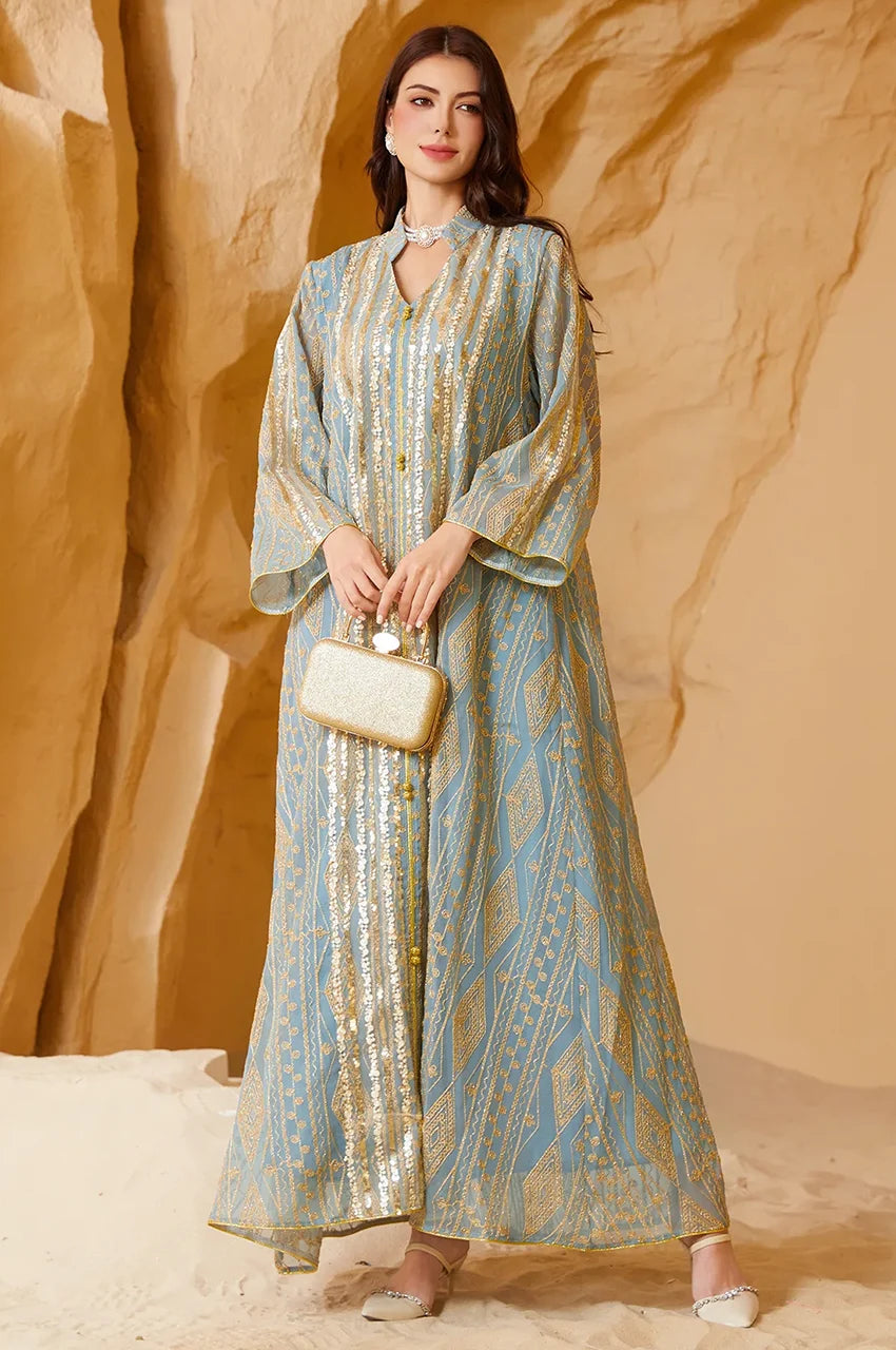 Styled look of the Yara Green Syrian Kaftan paired with a gold clutch bag for formal events.
