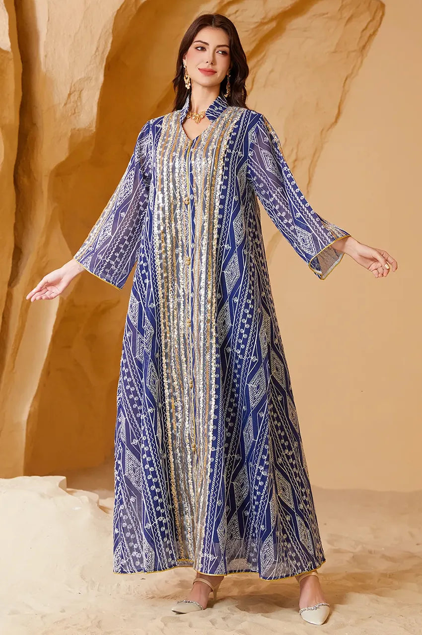Model displaying the wide bell sleeves and sheer overlay of the Naylara Yara Blue Kaftan for evening wear.