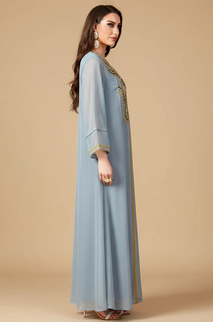Side profile of Zaliya Gray kaftan dress displaying long sleeves with detailed gold embroidery.