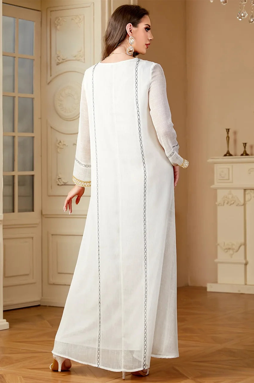 Sophisticated Egyptian style Zaliya White kaftan modeled in a luxury setting.