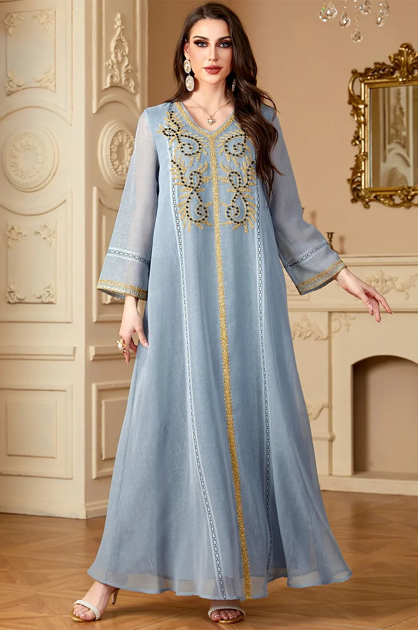 Zaliya Slate Gray maxi kaftan dress modeled to show loose fit and elegant gold arabesque patterns.