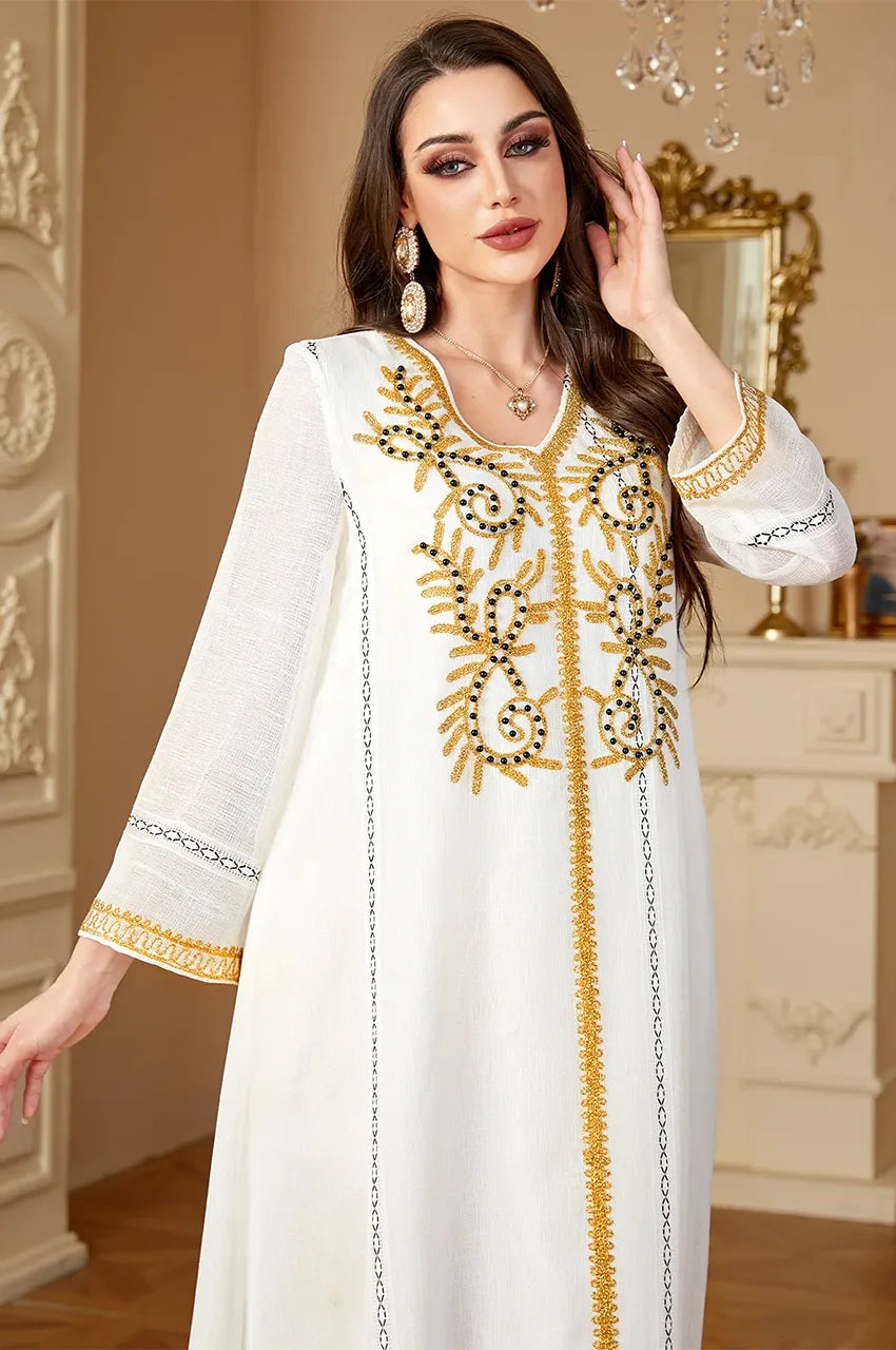 Model wearing Zaliya White embroidered kaftan with gold details, perfect for Nikah or formal occasions.