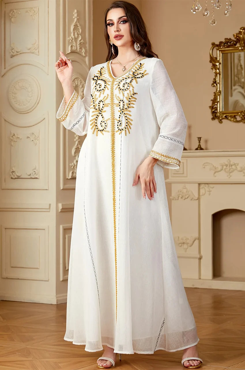 Hgh-quality gold and noir embroidery on Zaliya White Egyptian kaftan fabric.