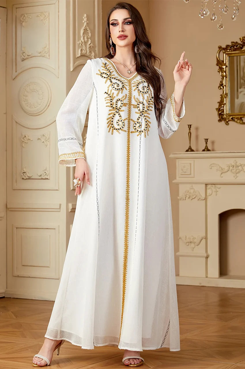 Zaliya White traditional kaftan with intricate gold arabesque stitching on the chest.