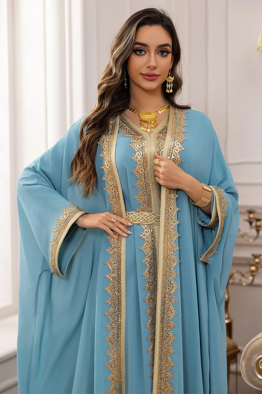 Detailed view of the gold Sfifa embroidery on the bodice of the sky blue long sheer kaftan.