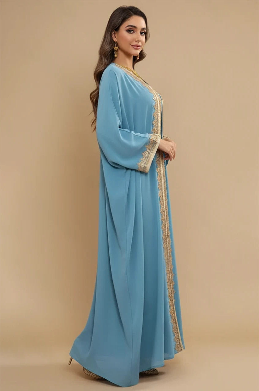Side profile of the NAYRA long sheer kaftan in sky blue with the braided gold belt.