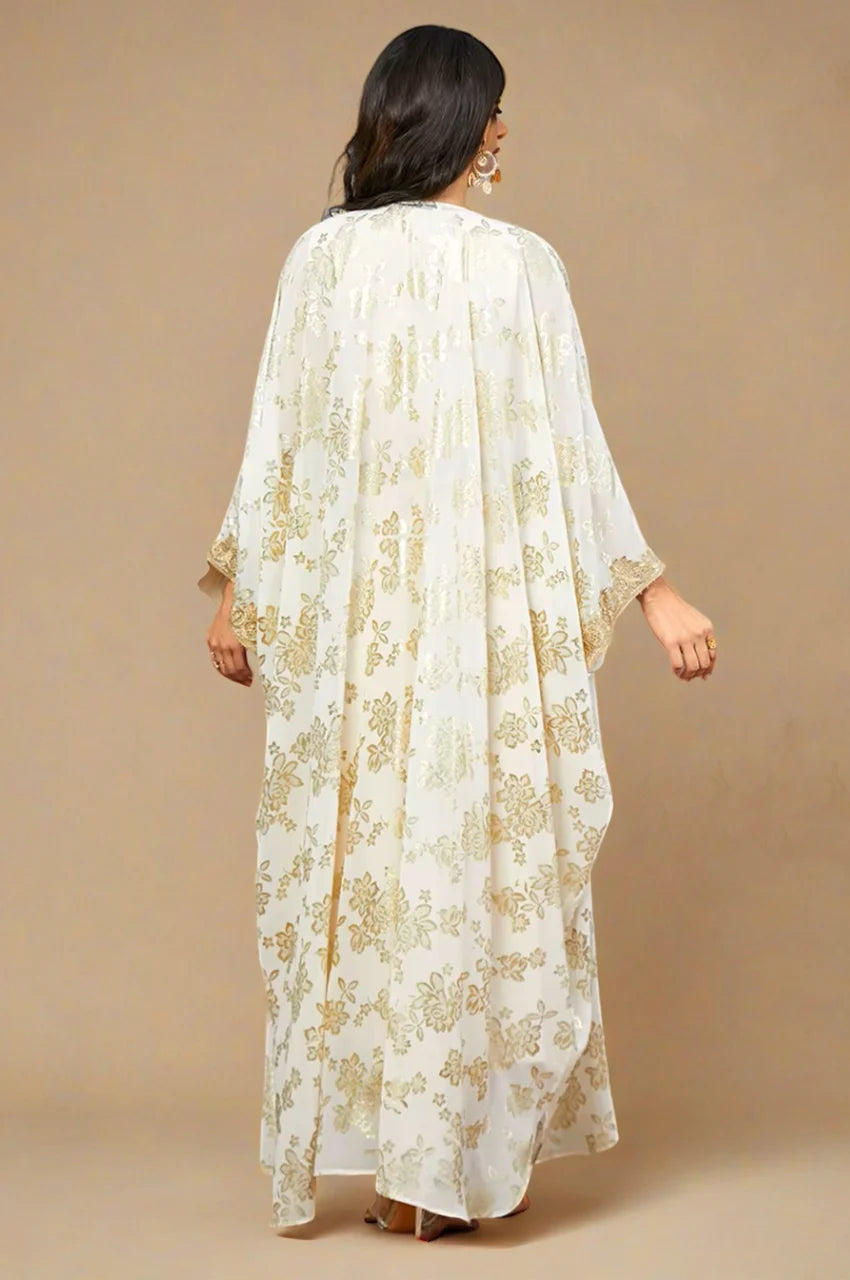 Back view of the Nehya white kaftan dress with gold floral print and flowing chiffon.