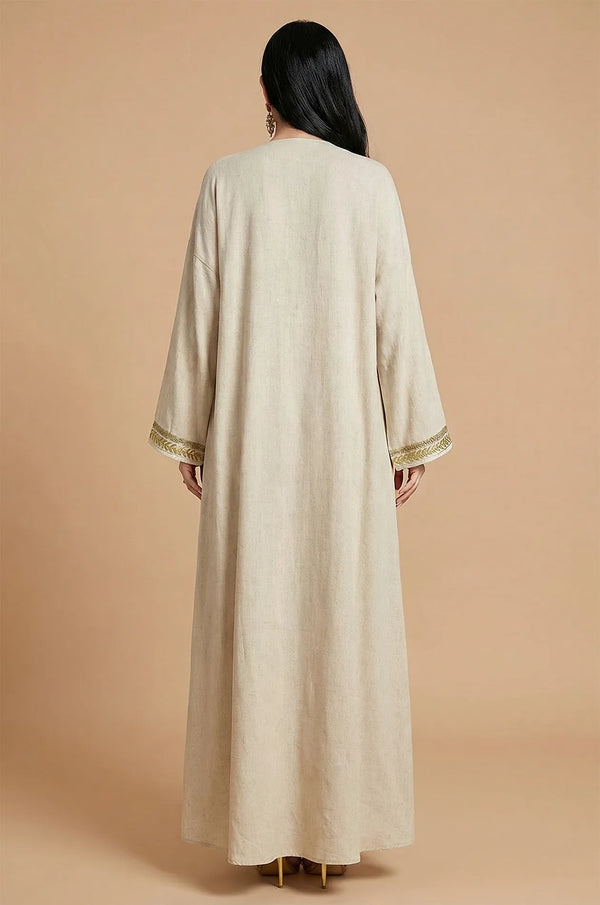 Rear view of the long-sleeved Ninon linen kaftan robe in sand beige.