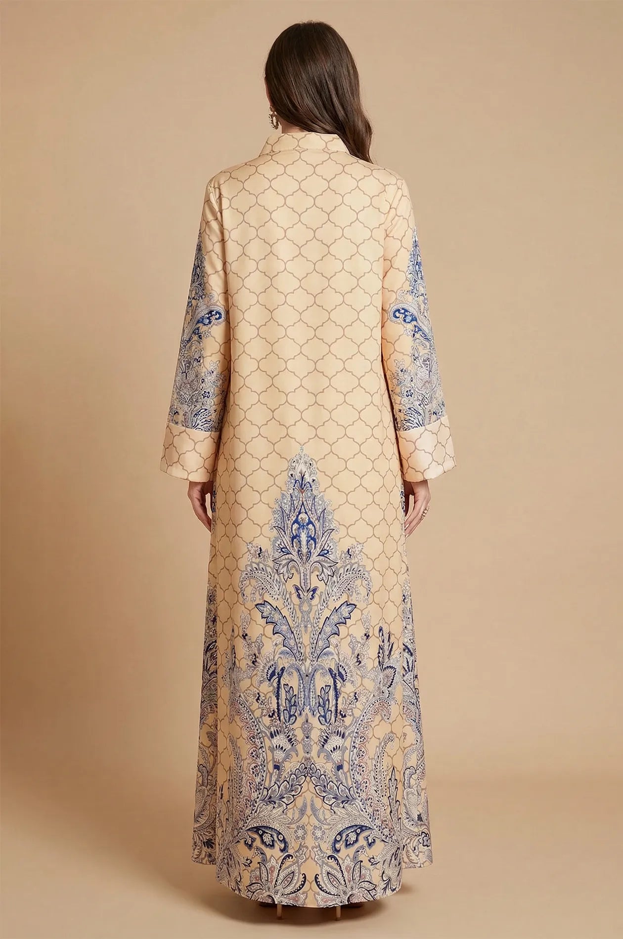 Back view of the Nirea beige paisley print kaftan highlighting the intricate blue and white patterns on the hem and sleeves.