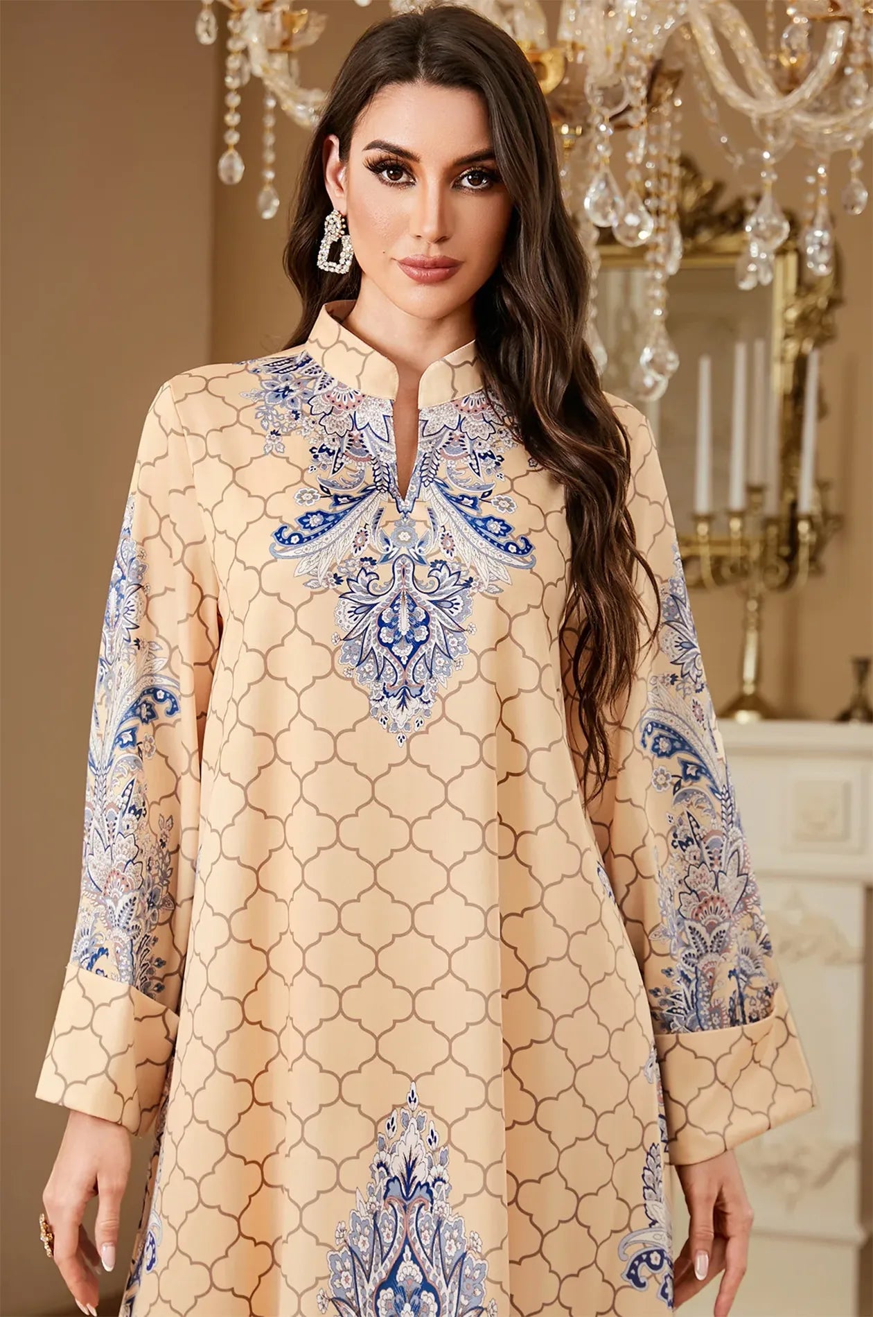 Close-up shot of the Nirea beige paisley print kaftan's V-neckline and intricate blue embroidery for a detailed product view.