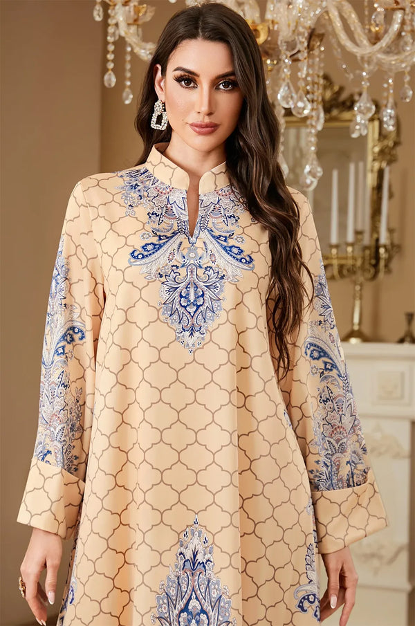 Close-up shot of the Nirea beige paisley print kaftan's V-neckline and intricate blue embroidery for a detailed product view.
