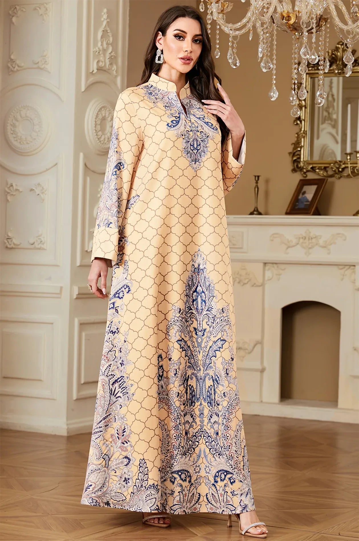 A regal standing pose of the Nirea beige paisley print kaftan, illustrating its sophisticated drape and luxury bohemian style.