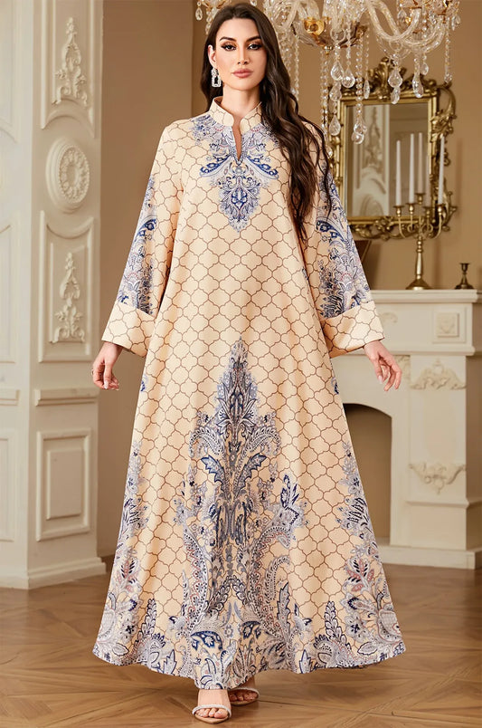 Elegant view of the Nirea beige paisley print kaftan by Naylara, featuring a floor-length silhouette and ornate blue arabesque detailing.