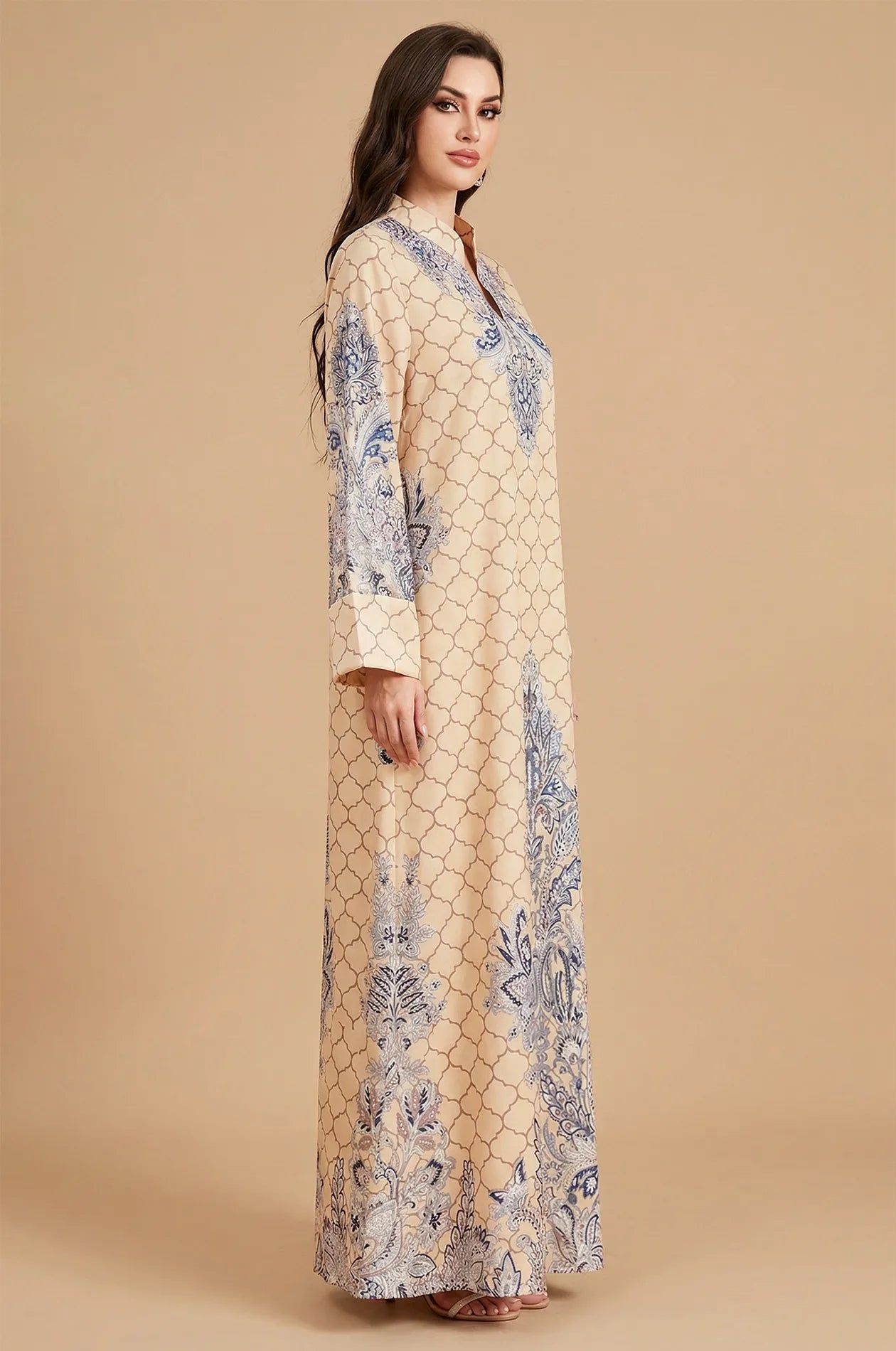 Side profile of the Nirea beige paisley print kaftan, demonstrating the modest long sleeves and lightweight, flowing A-line fit.